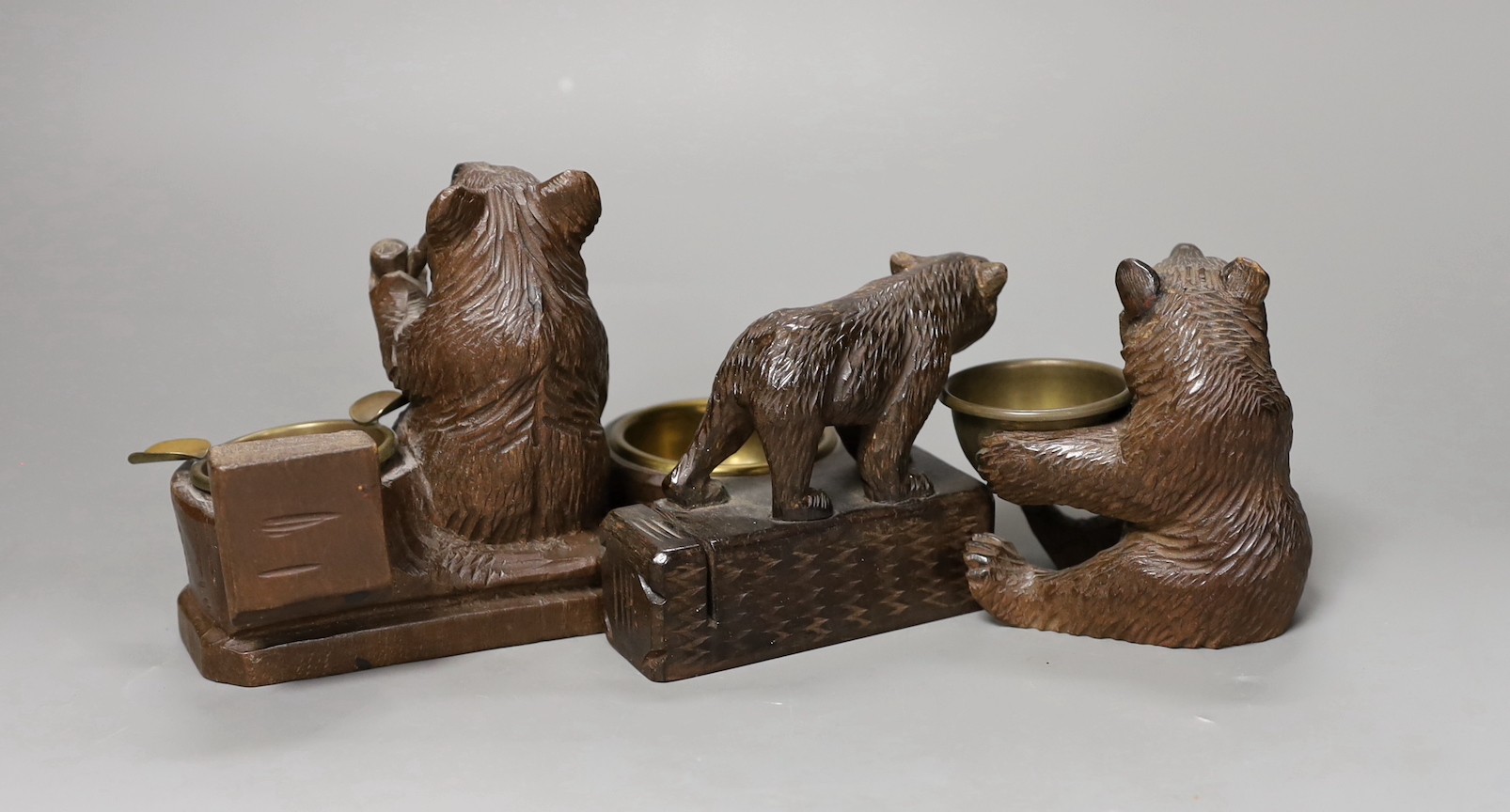 Three Black Forest ‘bear’ match-holders, tallest 11cm